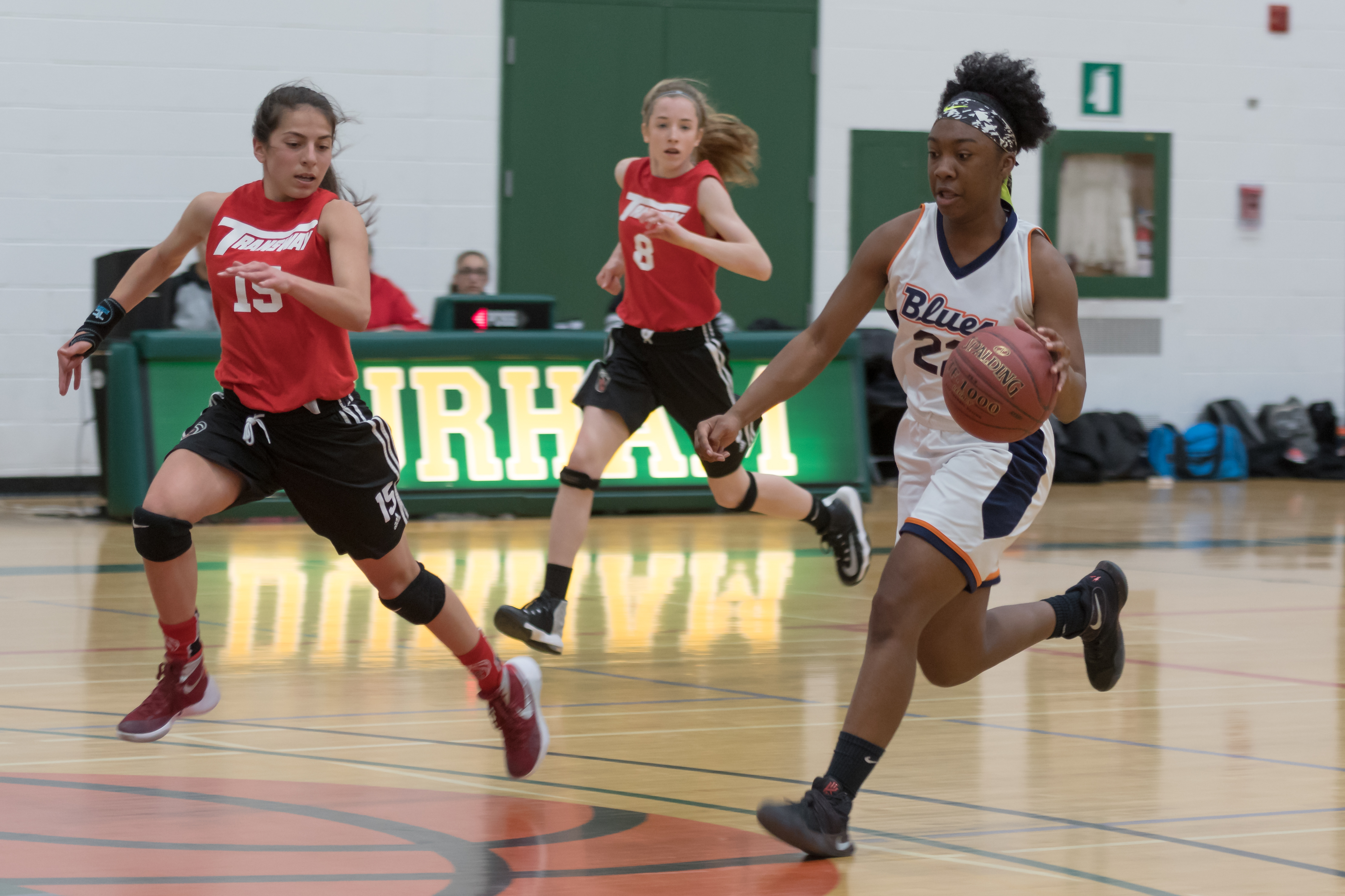 Multiple people playing basketball