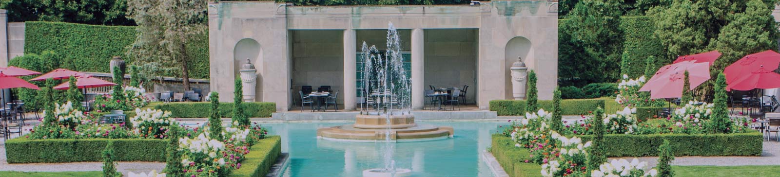 Fountains and gardens with the Tea House in the background at Parkwood National Historic Site.