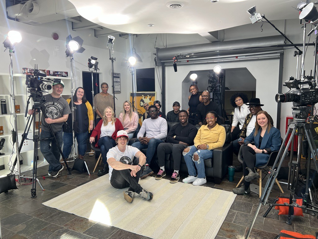 A group of people smiling in a production studio at geekspeak Commerce in Whitby, Ontario