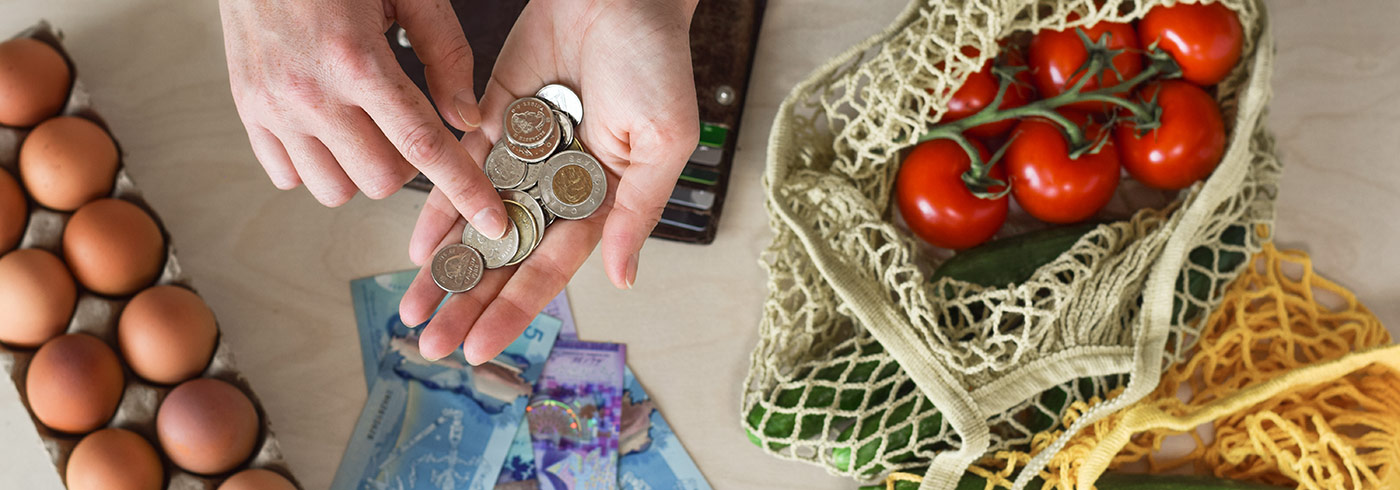 Hands counting money over food on the table Hands counting money over food on the table