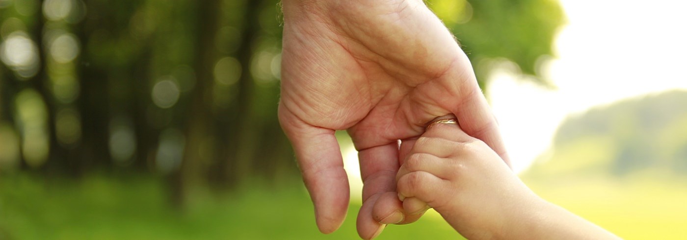 Child holding parents hand