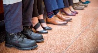 Employees feet in focus as they sit on a bench
