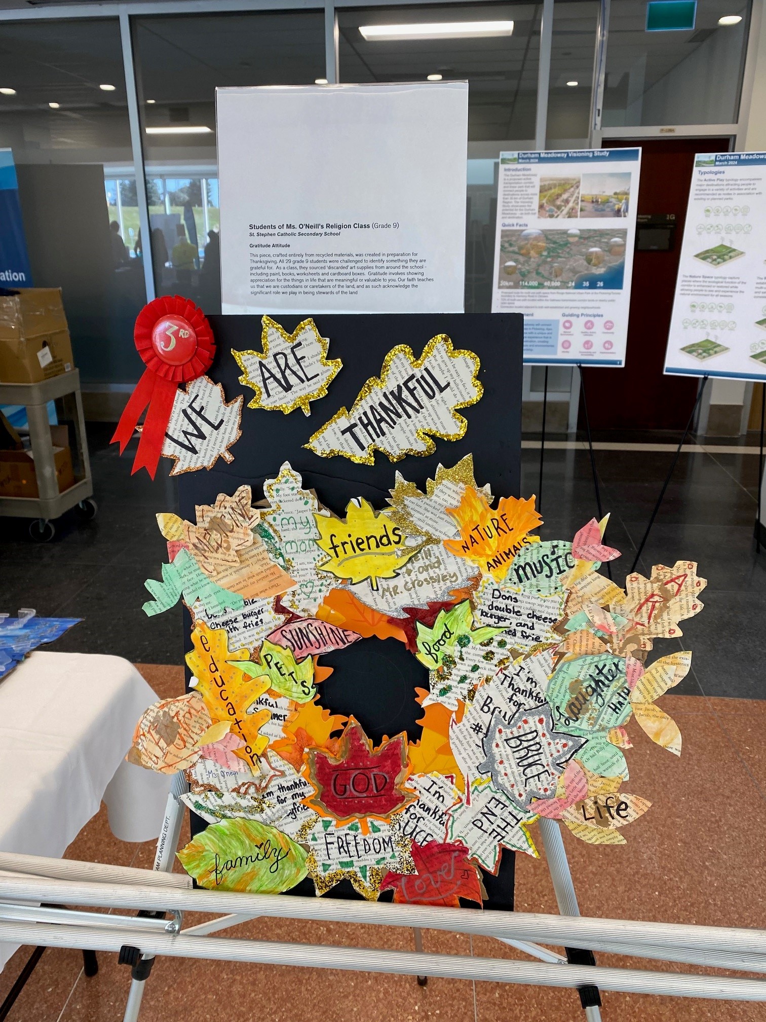 Artwork depicting things that grade 9 students are grateful for, written on an arrangement of fall leaves