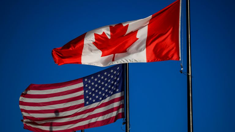 The Canadian and American flag side by side.