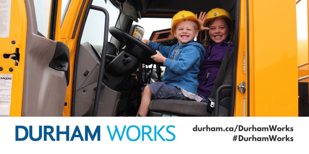 An image of children sitting in a truck with yellow hard hats smiling. Text below reads "Durham Works durham.ca/DurhamWorks #DurhamWorks"