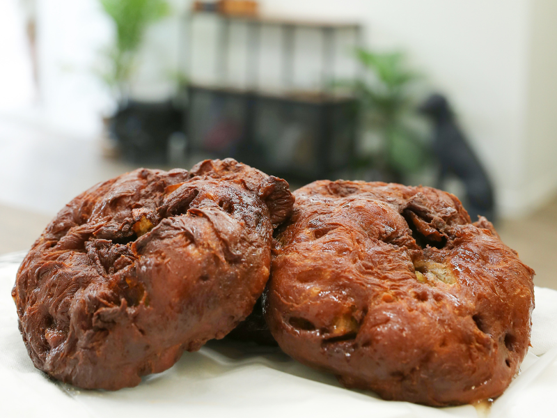 Image of two large apple fritters at a bakery