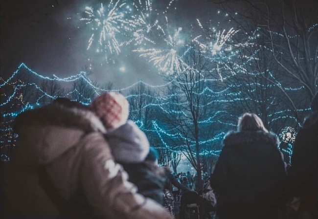 Image of a crowd watching fireworks on New Year's Eve