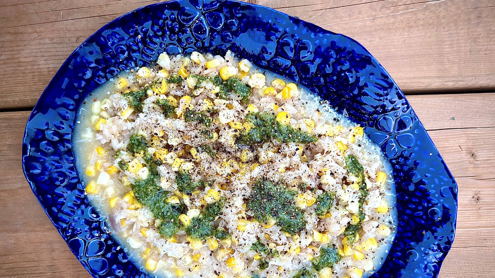 Corn Risotto with Sunflower Seed Pesto by Chef Alex Page in a blue dish from Greenmantle Pottery in Uxbridge, Ontario