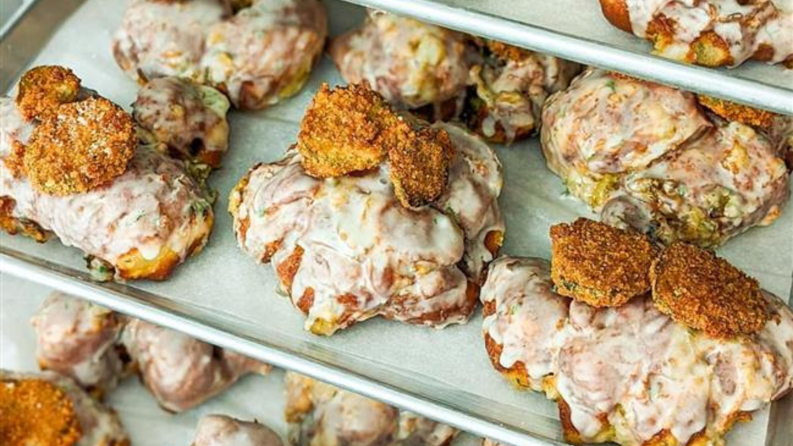 Trays of dill pickle fritters topped with dill icing and deep fried pickles