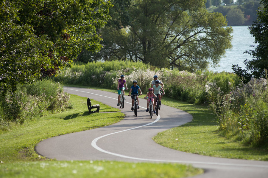 Family cycling along the lakeshore in Ajax in the summertime.