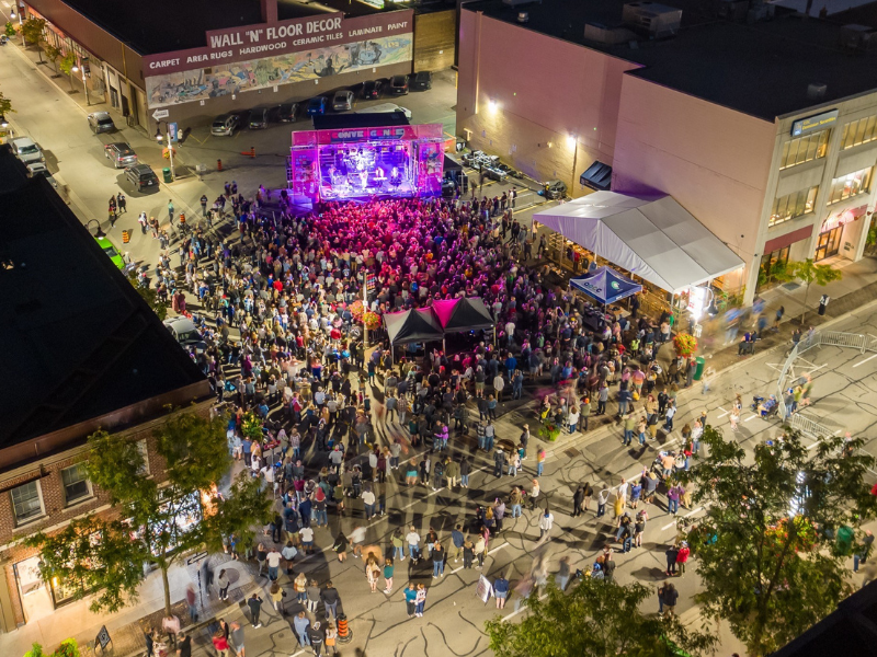 Aerial view of an outdoor stage with a large crowd at Convergence Festival