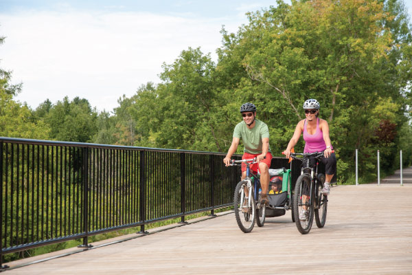 Family cycling on Trestle Bridge in Uxbridge.