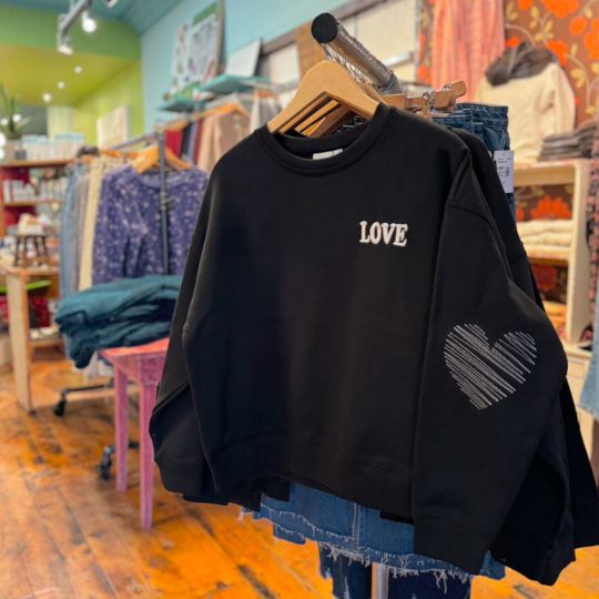 Sweatshirt on display at Gather boutique in Bowmanville, Ontario