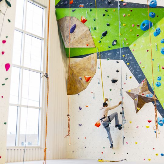 Person climbing a rock wall at Aspire Climbing in Whitby, Ontario