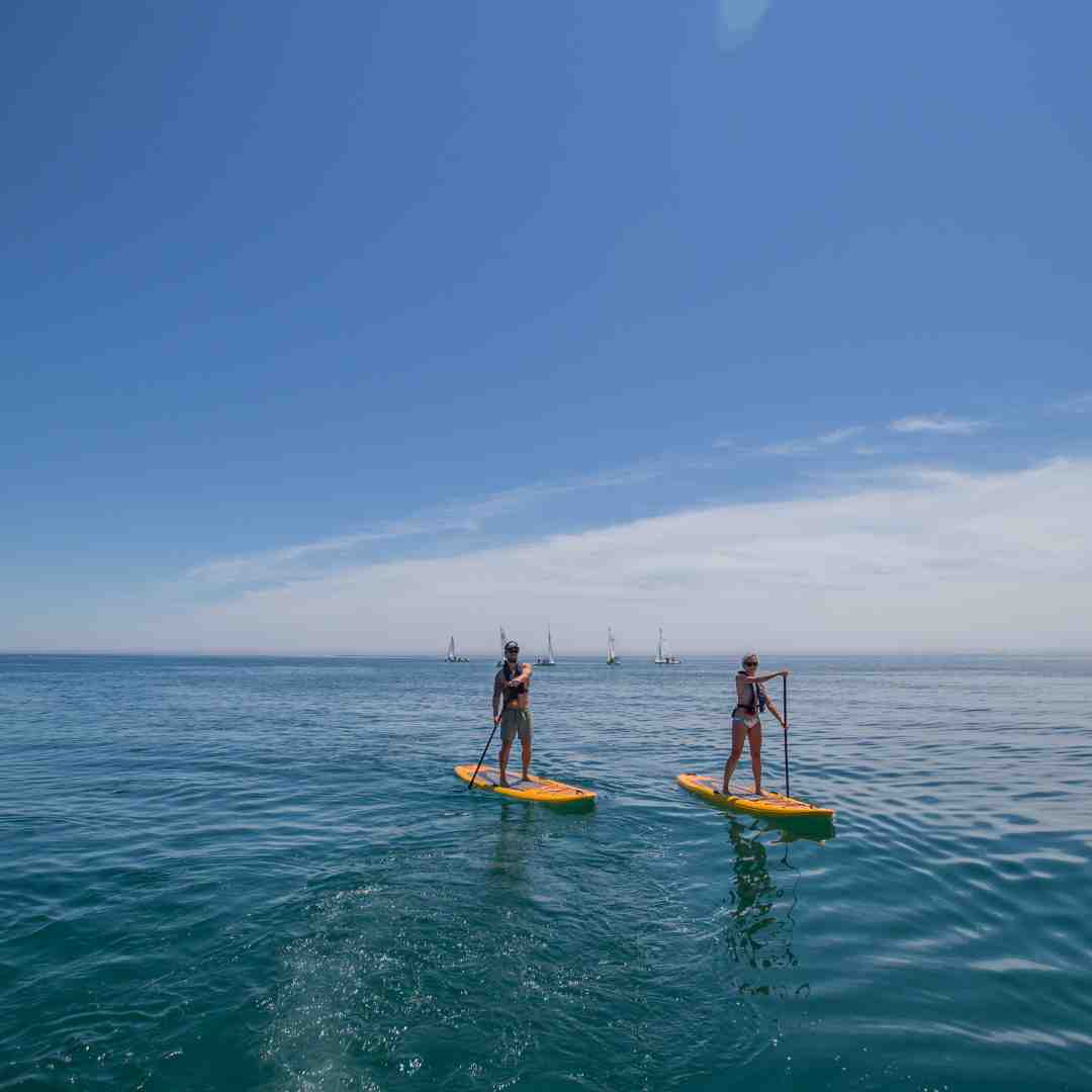 Two people on stand up paddle boards on Lake Ontario in Durham Region, Ontario