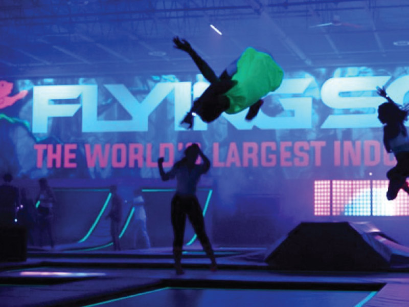 People jumping on a trampoline indoors at iFly.