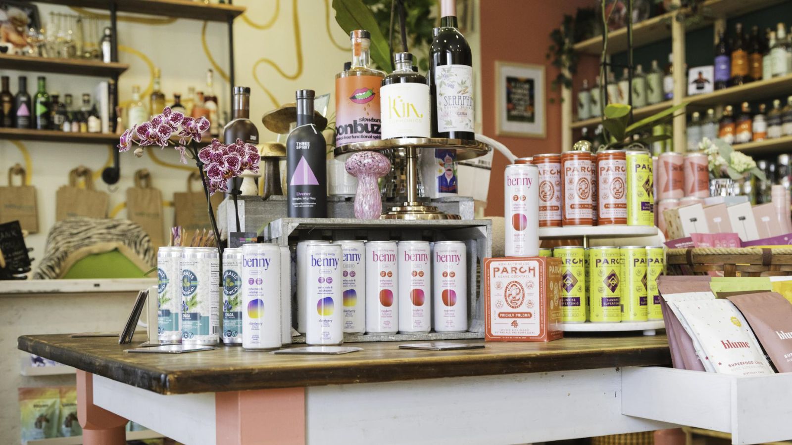 Image of the interior of a bottle shop stocked with bottles of different sizes and colours